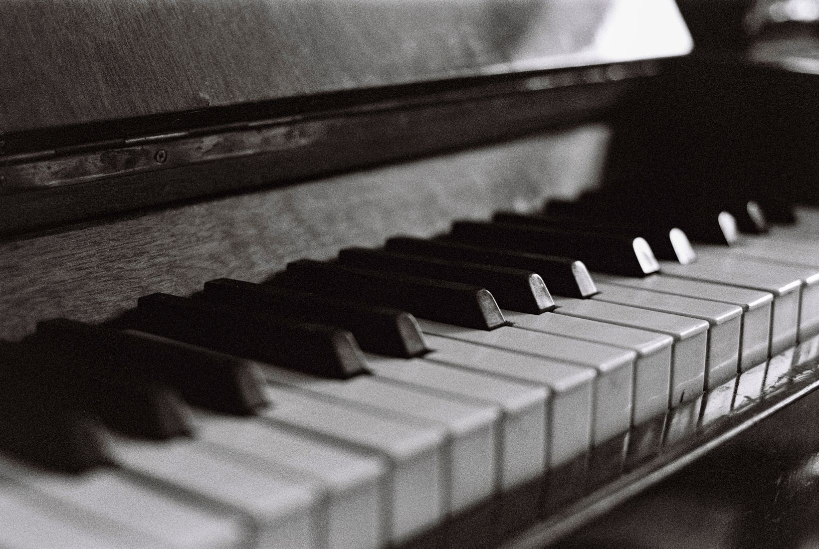 Grayscale Photo of a Piano